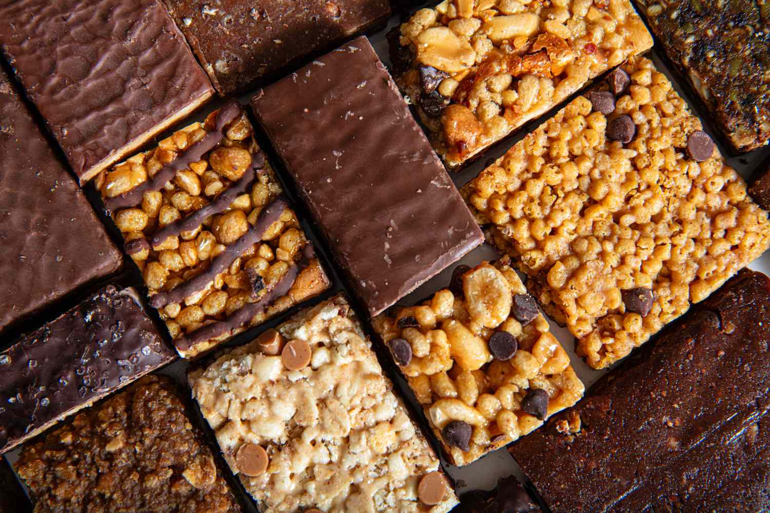 An assortment of protein bars arranged in rows