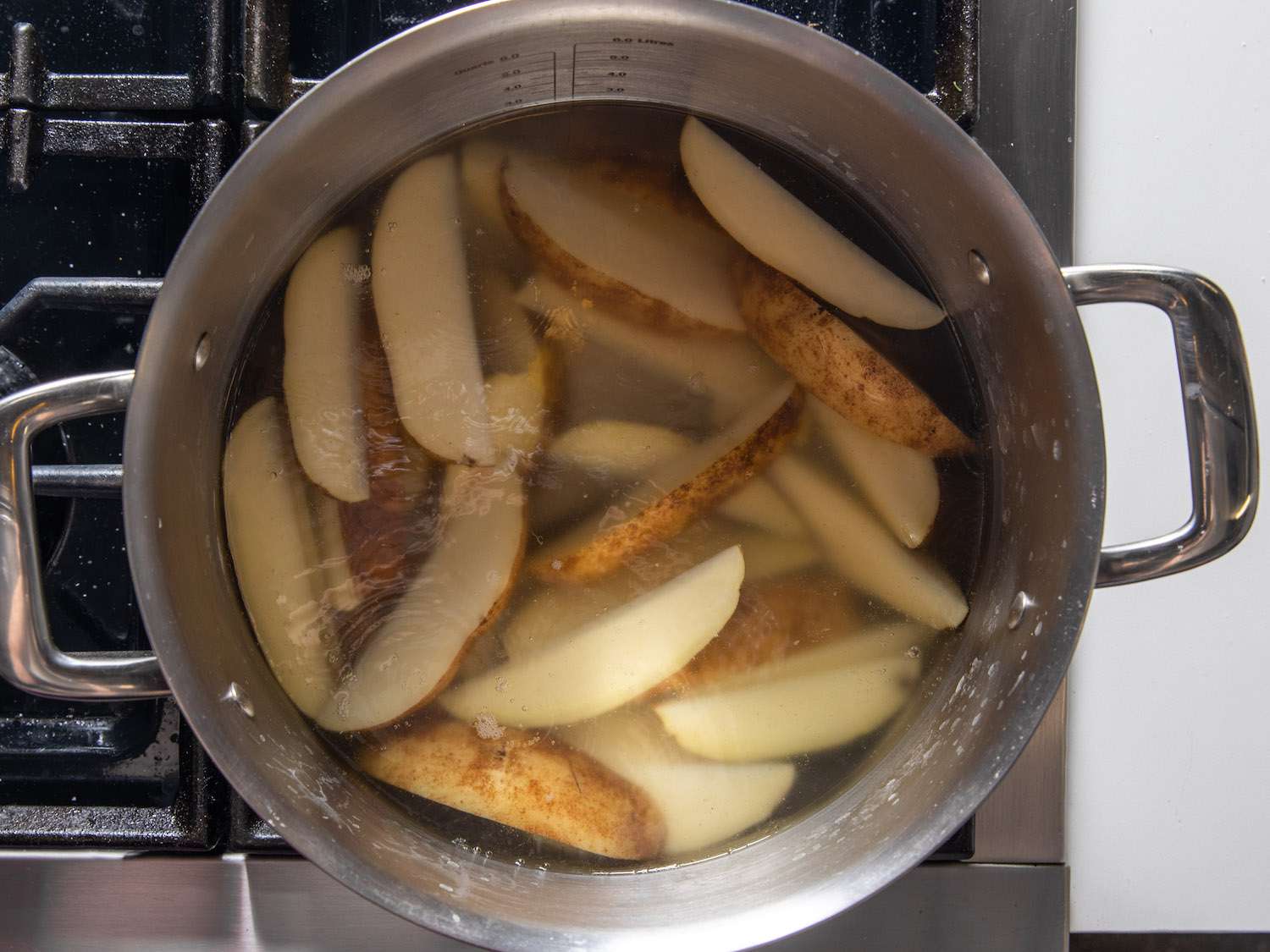 Simmering potato wedges in alkaline water
