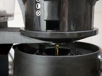 A closeup of the brewed coffee flowing from the basket into the carafe. 