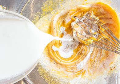 Half and half being poured into a bowl. 