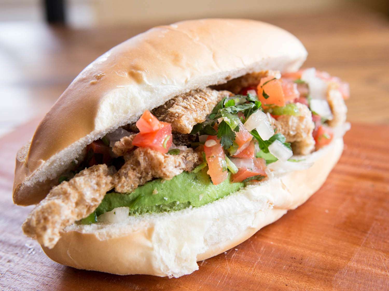 guacamaya sandwich stuffed with chicarrones and pico de gallo