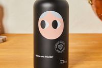 A bottle of Yiayia and Friends extra virgin olive oil on a wooden surface