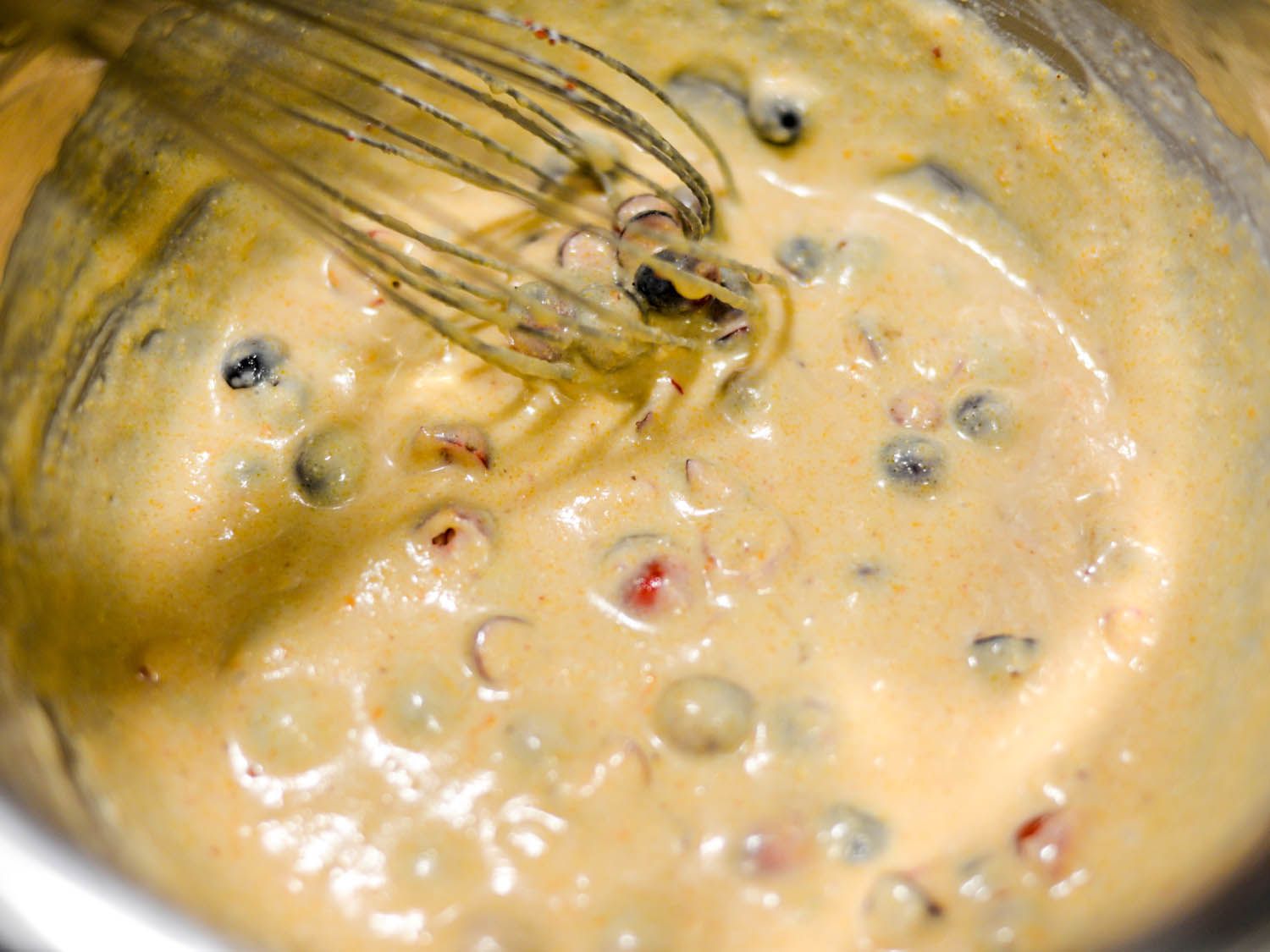 Whisking orange cranberry cornbread batter.