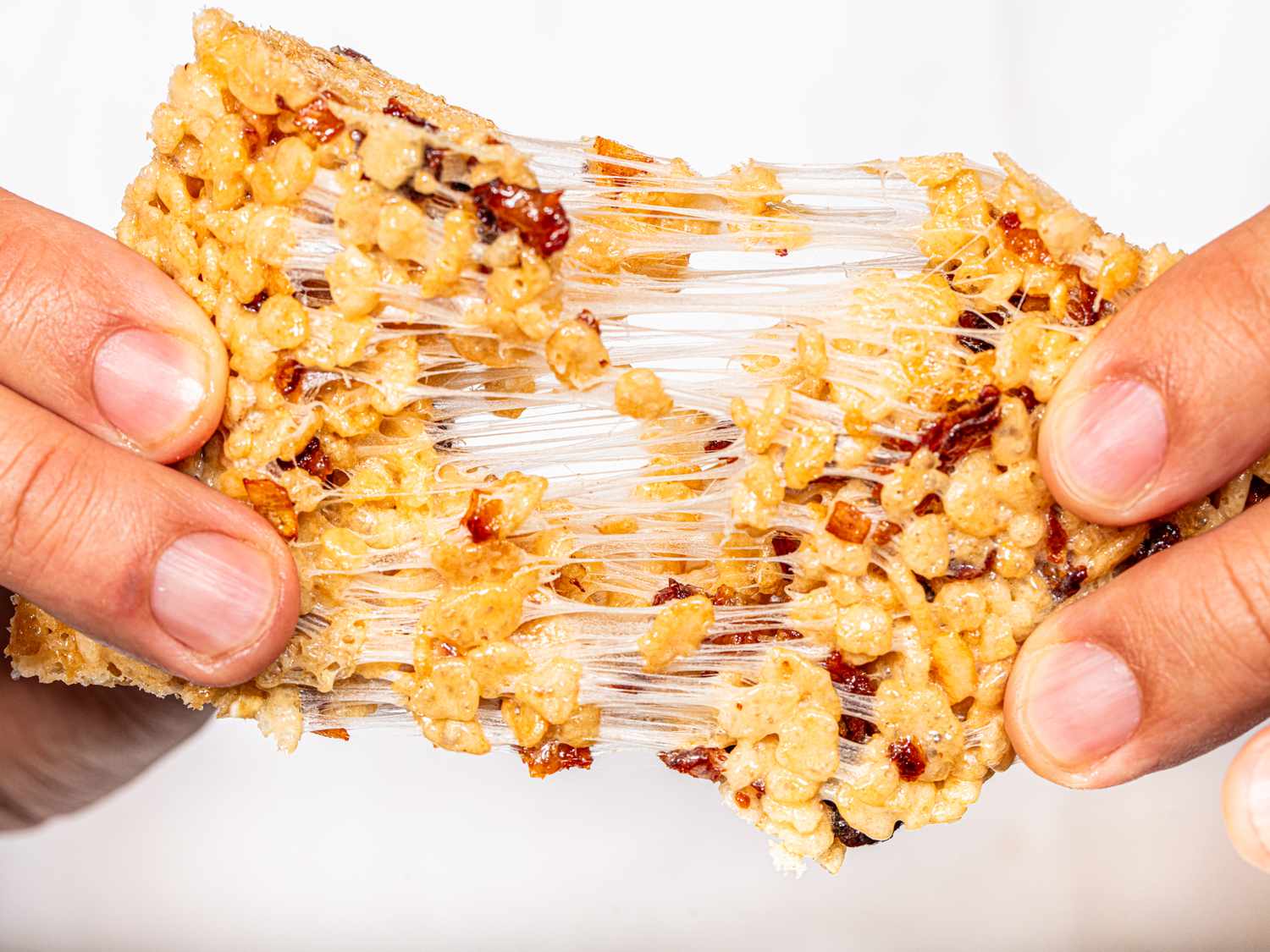 Side view of pulling rice krispie treat apart