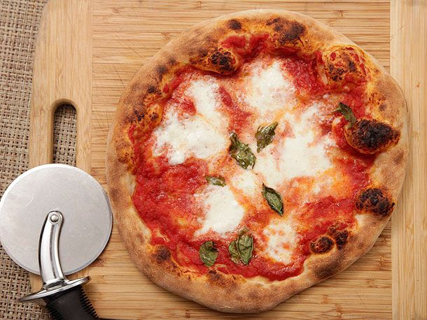 A pizza on a wooden cutting board. 