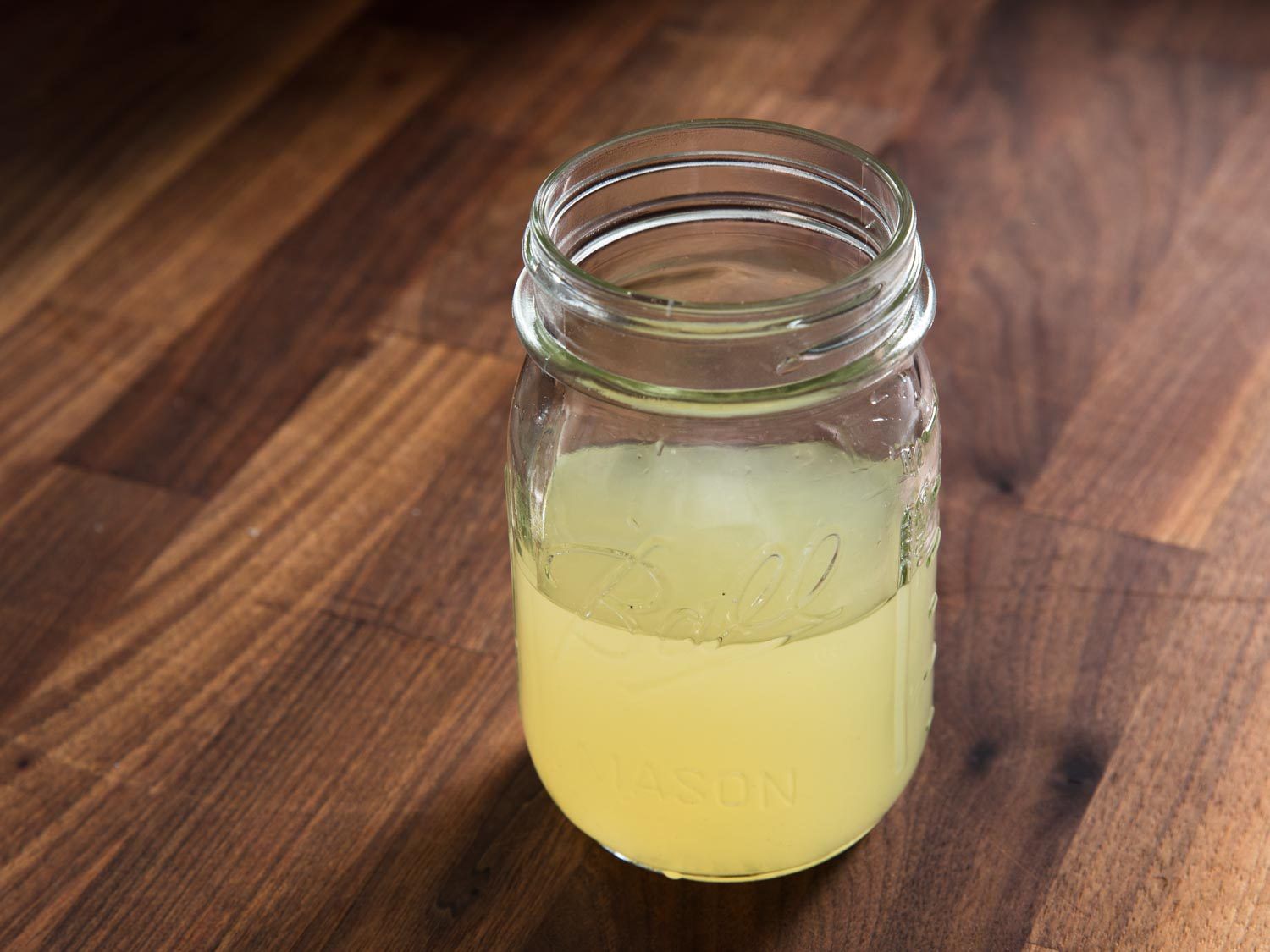 Finished shio tare made of lemon-salt solution and kombu dashi, in a glass jar.
