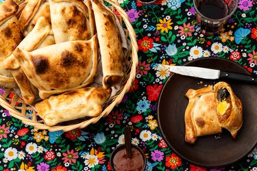 Overhead view of Empanadas de Pino on a traditional Chilean fabric