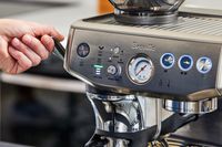 A person adjusting the Breville Barista Express Impress
