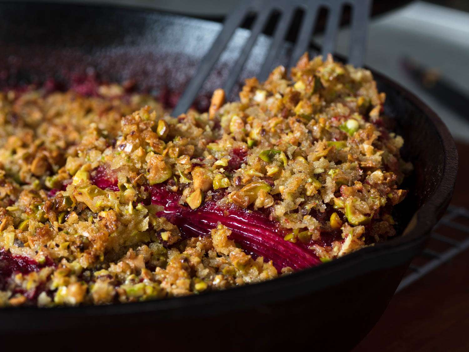 Closeup of the beet gratin being served with a fish turner.
