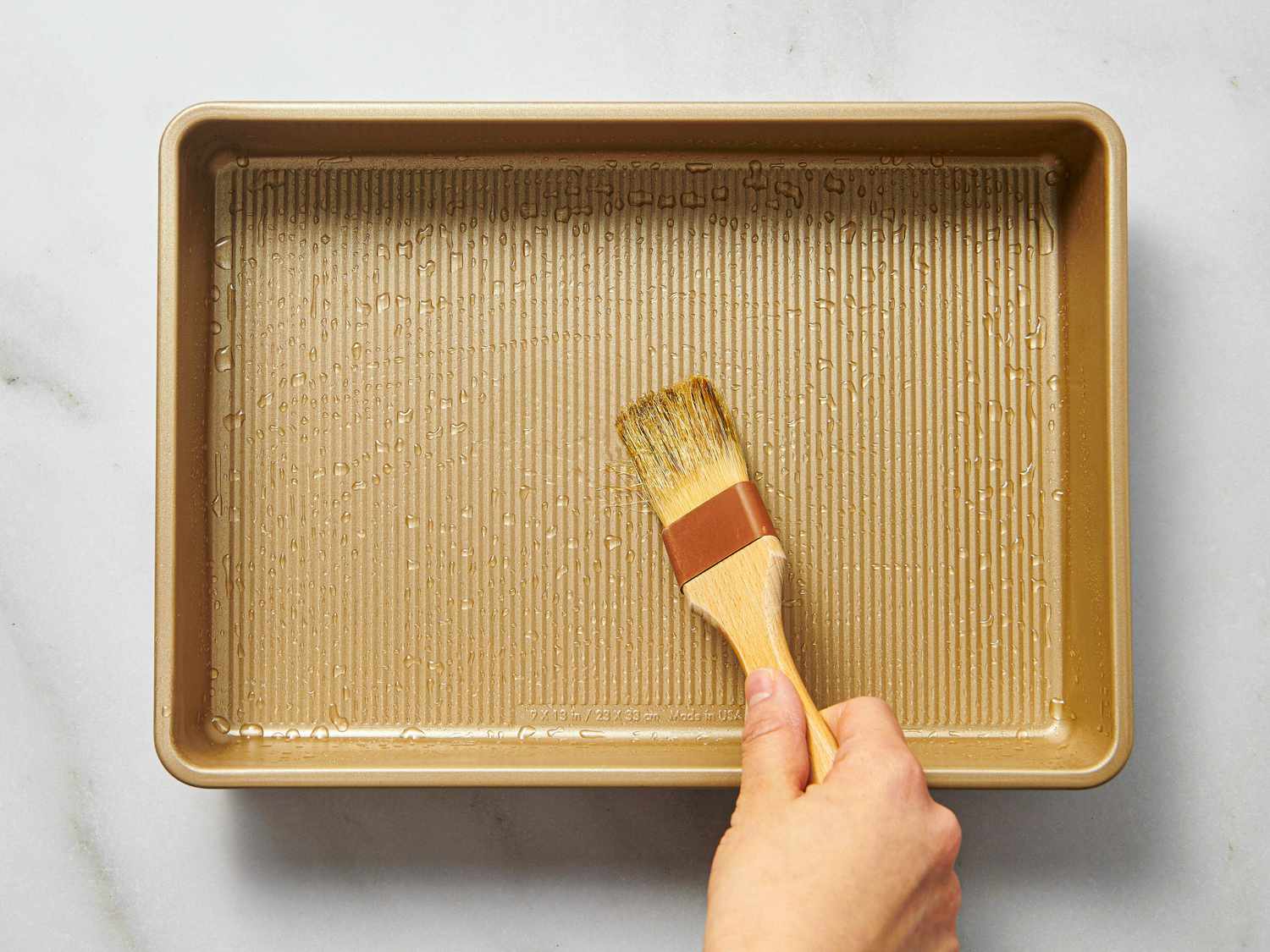 Overhead view of oiling a pan