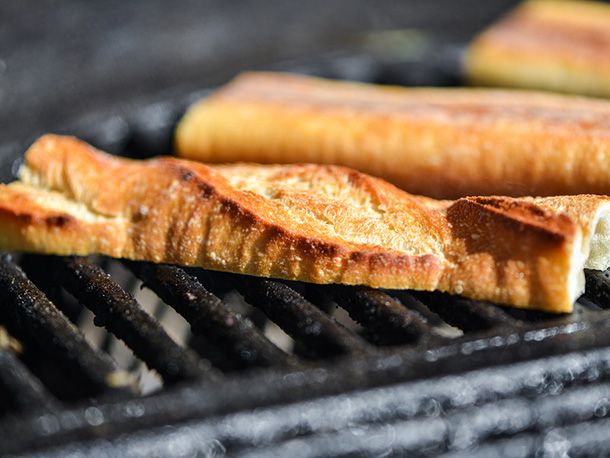 Sections of baguette being grilled cut side down