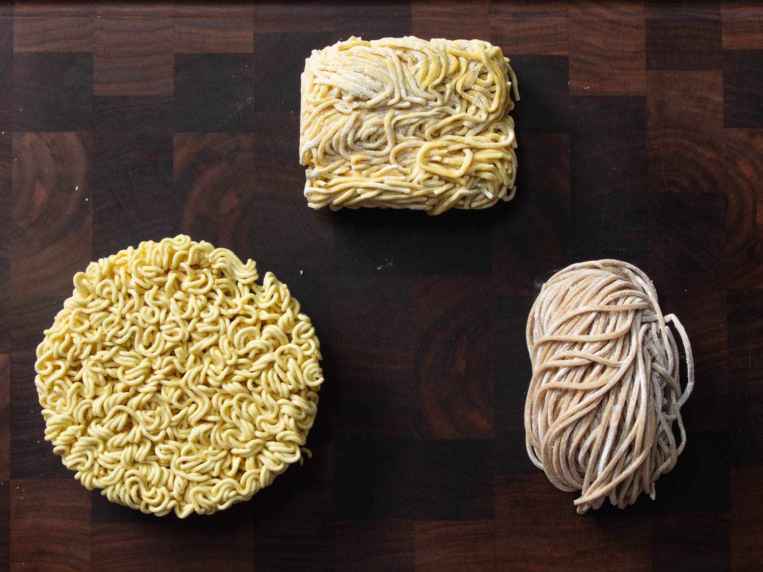 Different varieties of ramen noodles: clockwise from bottom left: Dried instant noodles, fresh store-bought noodles, homemade noodles.