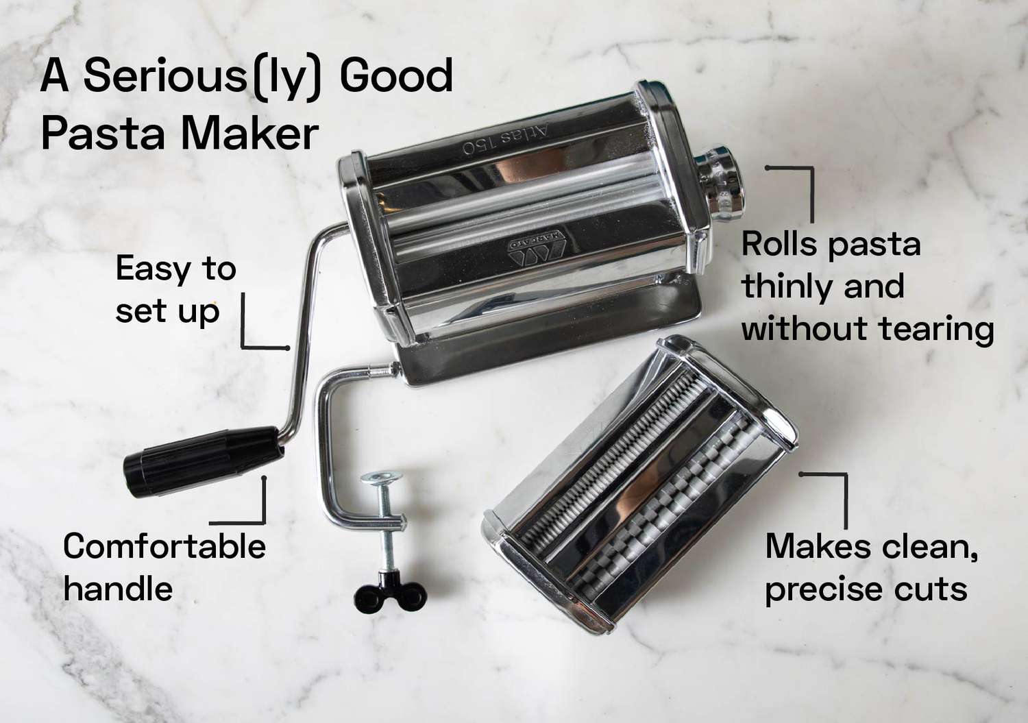A stainless steel pasta maker on a marble countertop