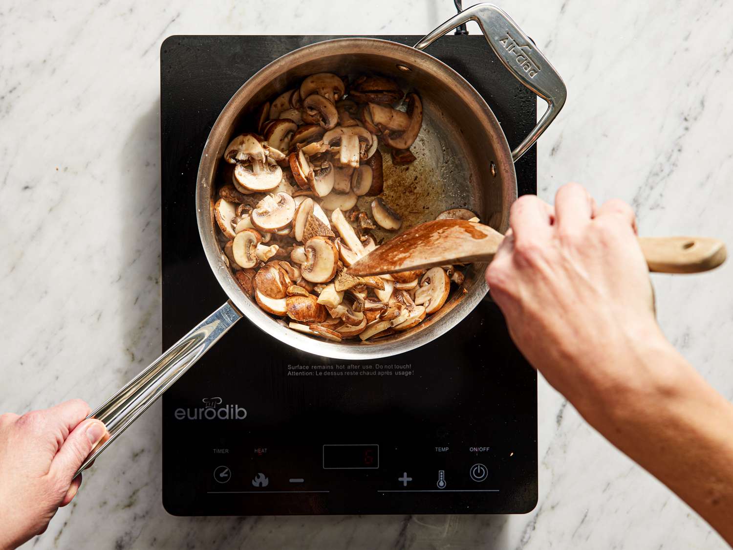 Stirring mushrooms in a saucepan