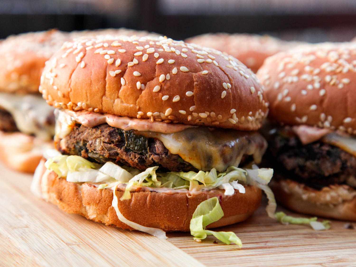 Black bean burgers on a bamboo cutting board. 