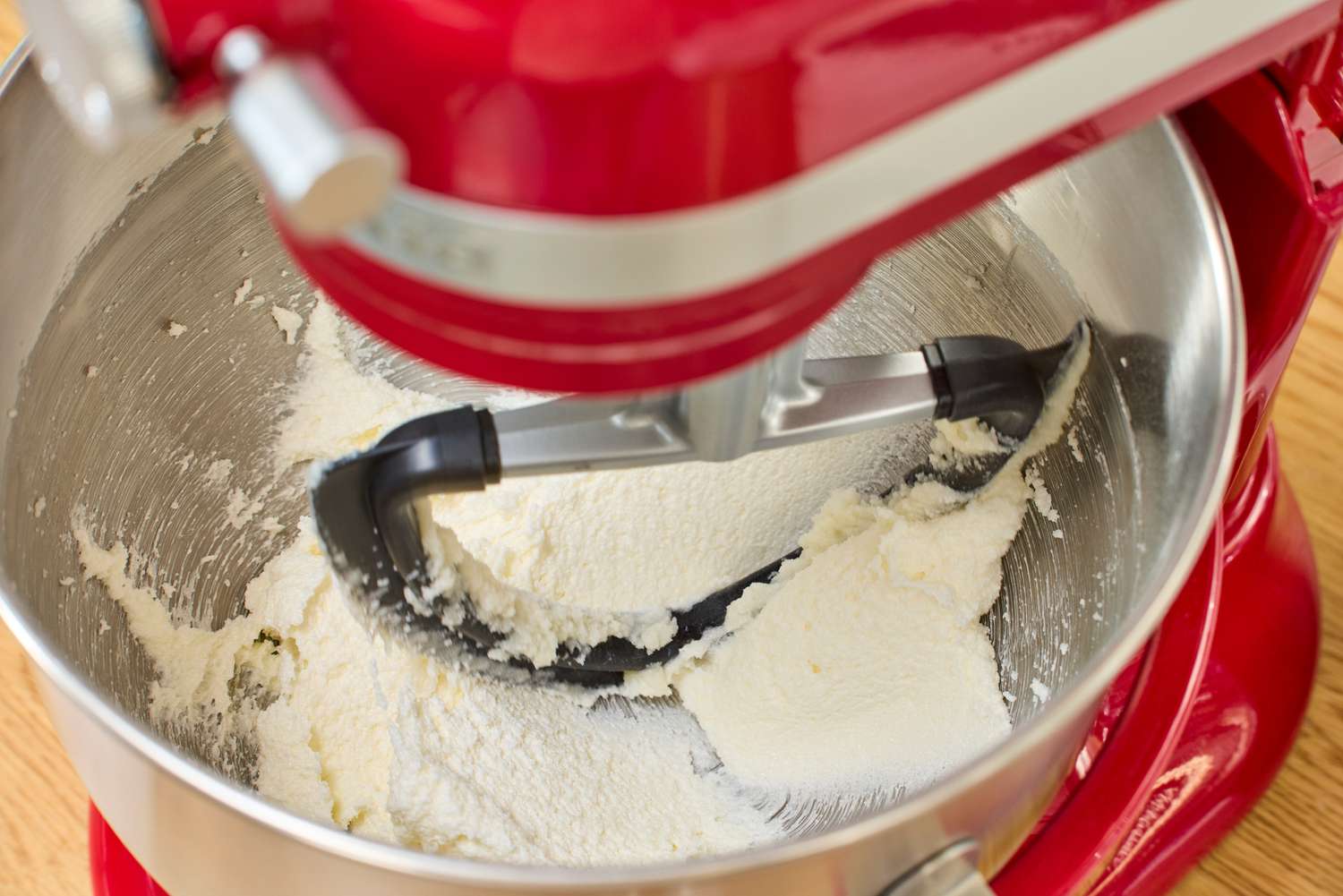 A person creams butter and sugar in the KitchenAid 7 Quart Bowl Lift Stand Mixer