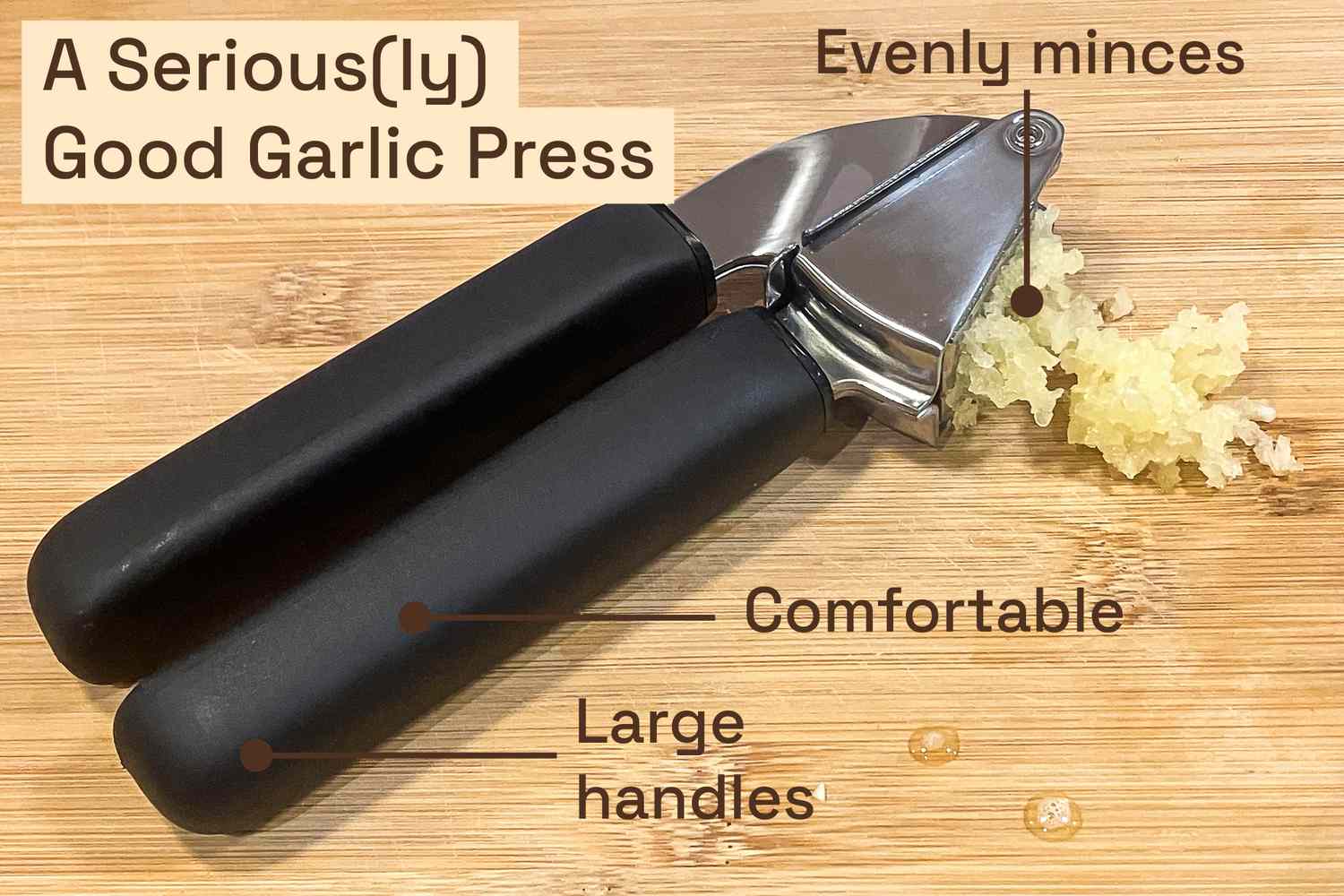 a garlic press on a cutting board with pressed garlic