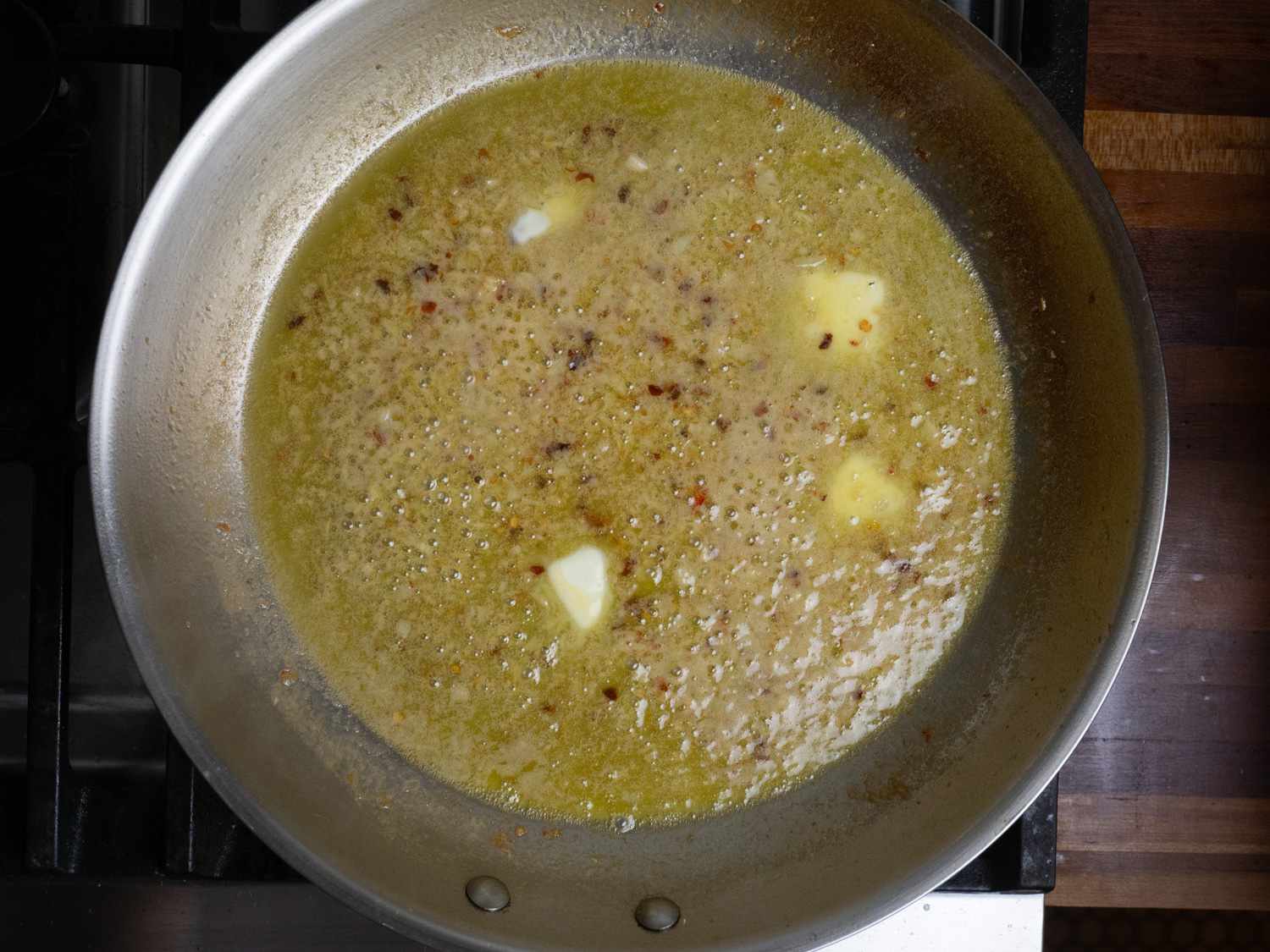 Butter added to the sauce in the skillet.