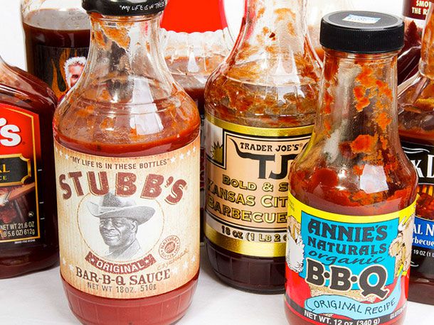 An assortment of bottled barbecue sauces on a table.
