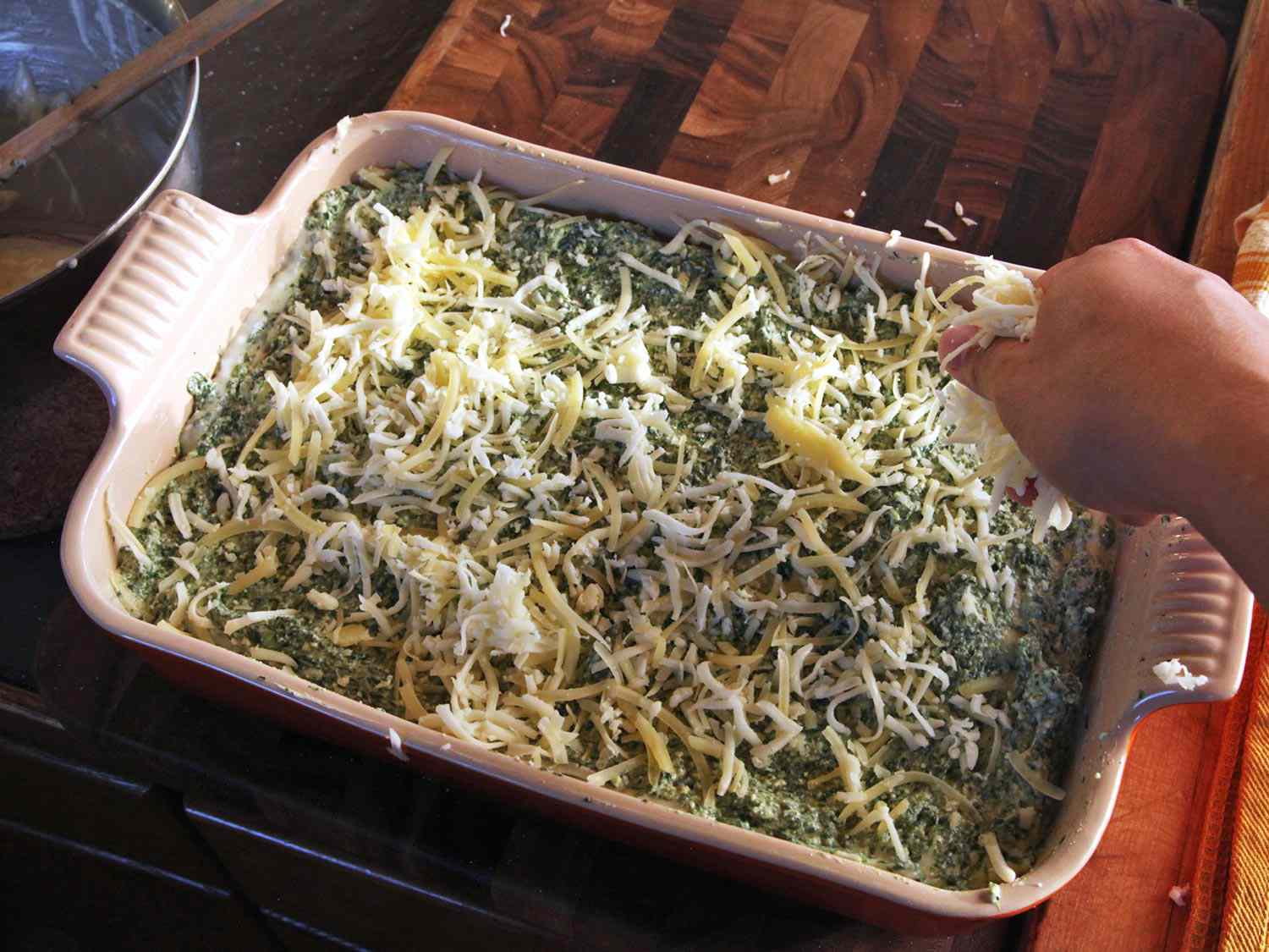 Topping lasagna stack with grated cheese