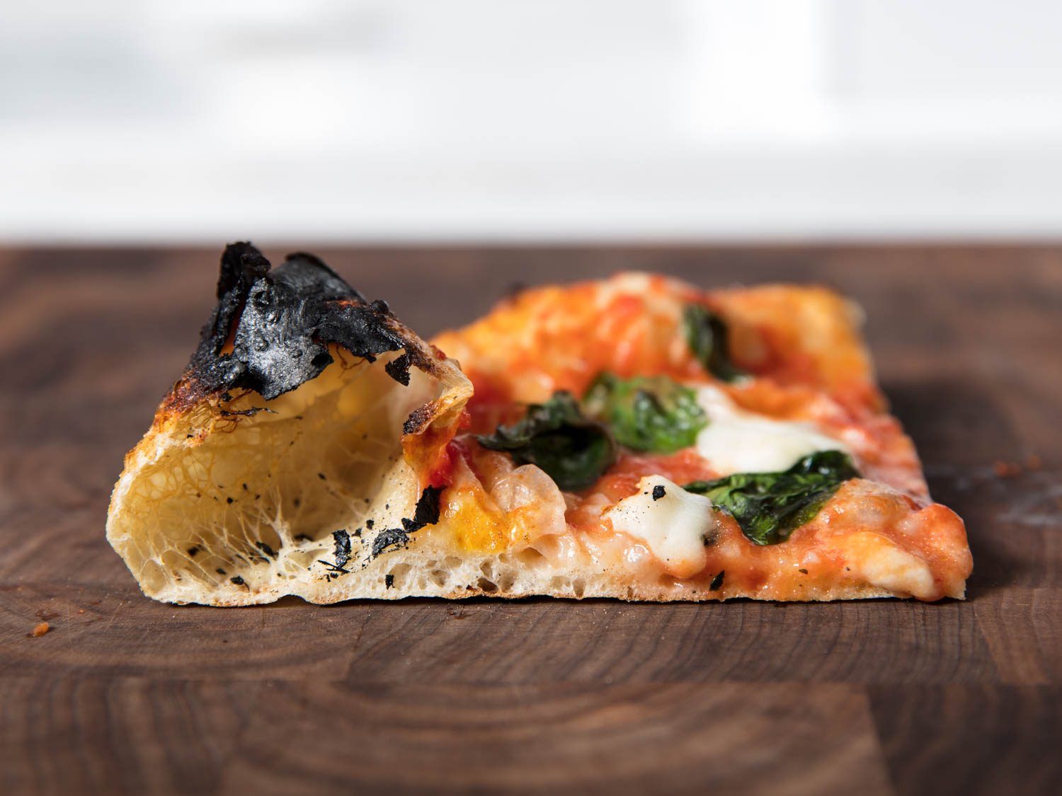 Side view of a slice from a pizza baked in the Breville oven.