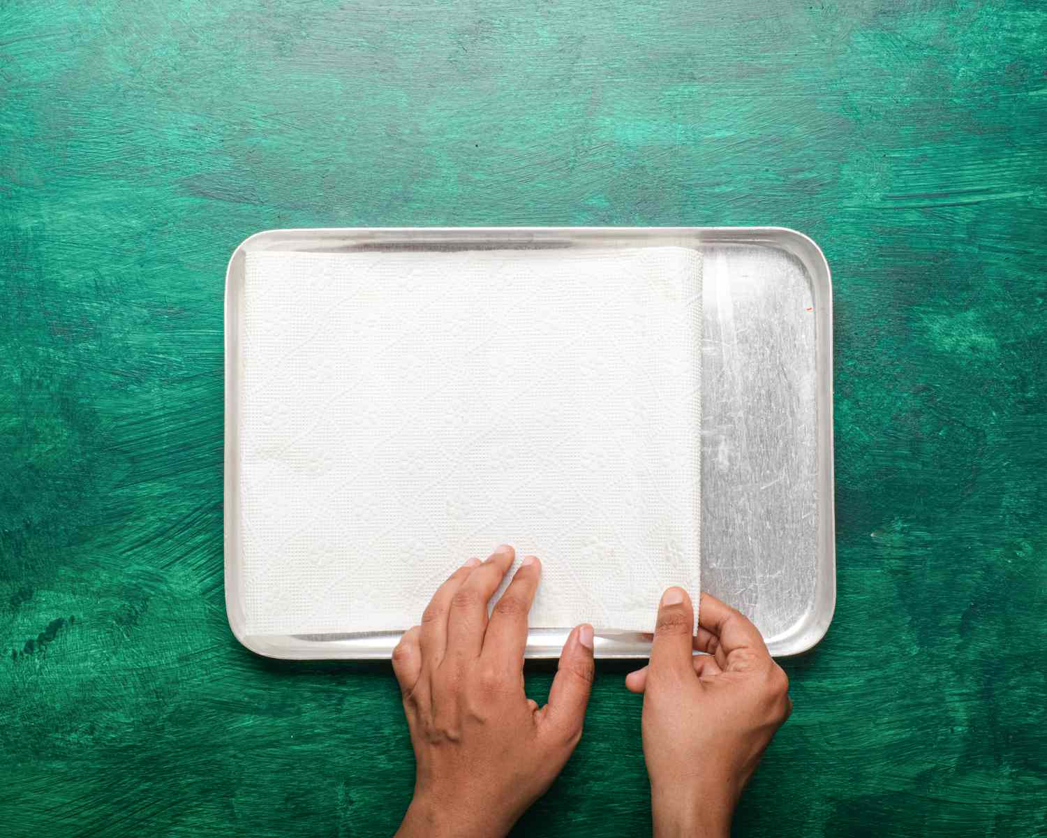 Overhead view of lining tray with paper towel