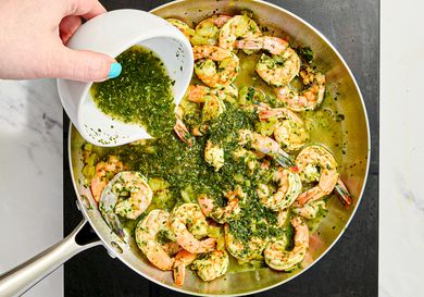 Overhead view of pouring chutney into pan