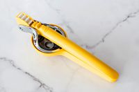 The Chef'n citrus juicer on a marble countertop.