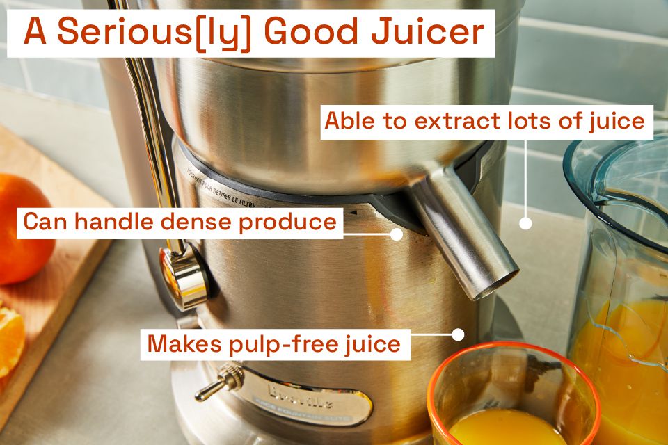 A stainless steel Breville juicer on a cluttered countertop