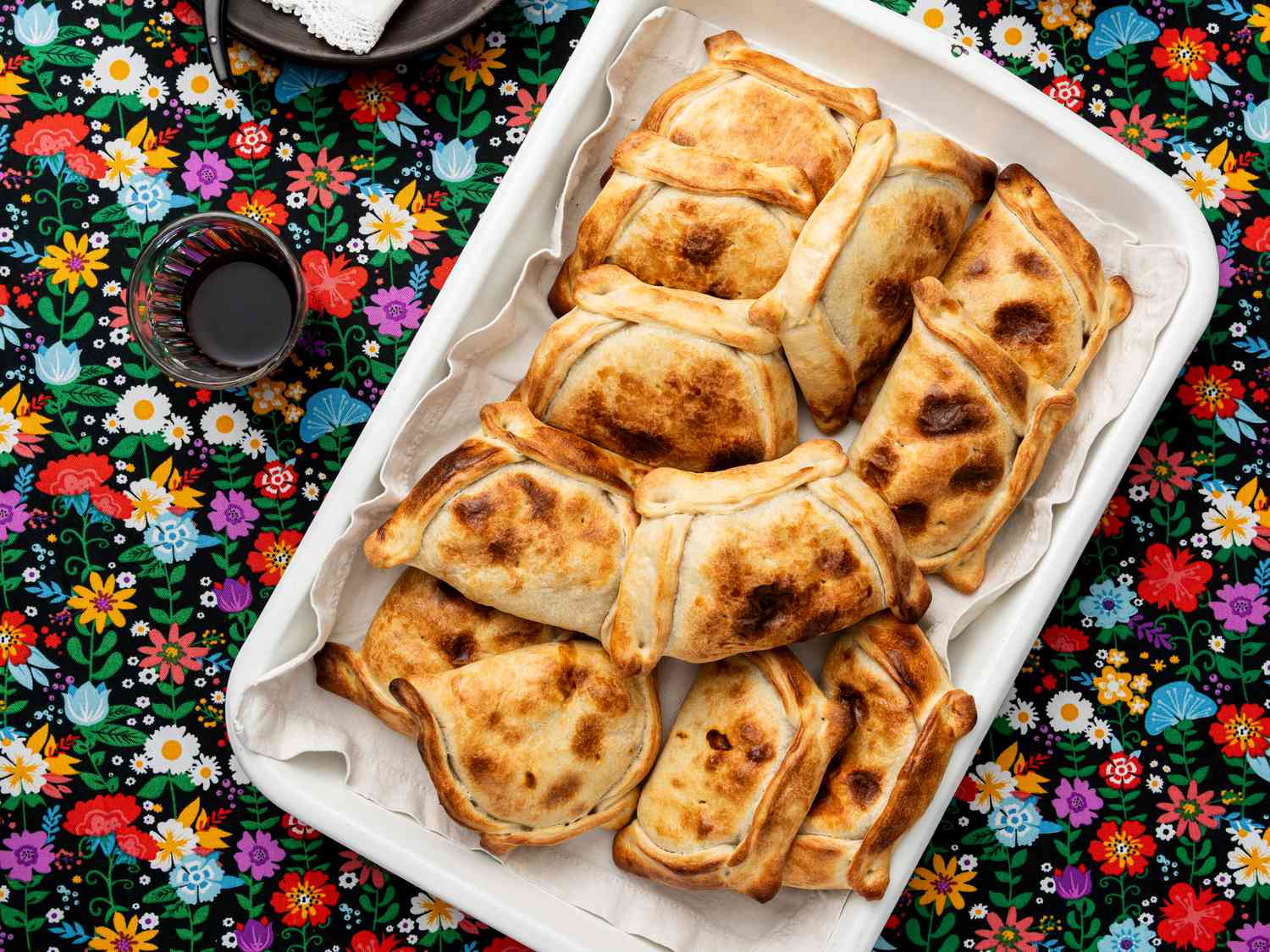Overhead view of Empanadas de Pino on a traditional Chilean fabric