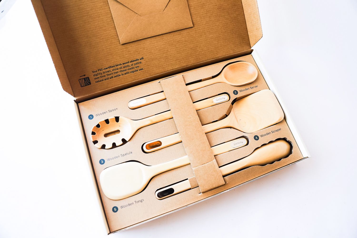 The Caraway kitchen utensil set in its packaging