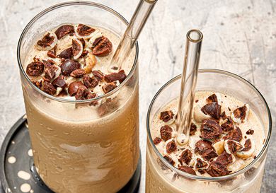 Overhead view of two coffee smoothies with glass straws