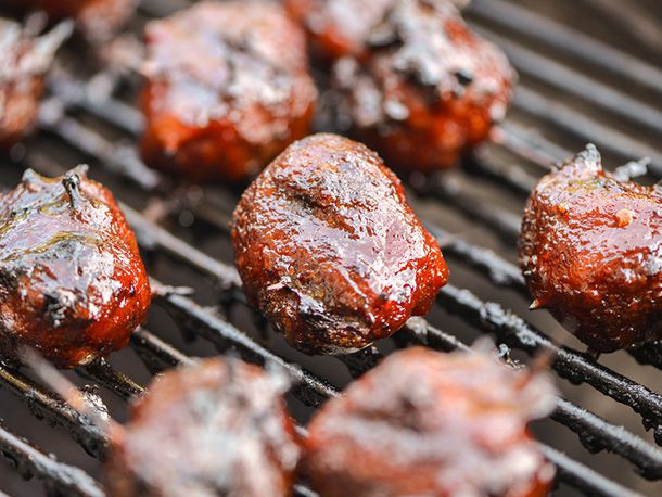 Glossy grilled MOINK meatballs on the grill.