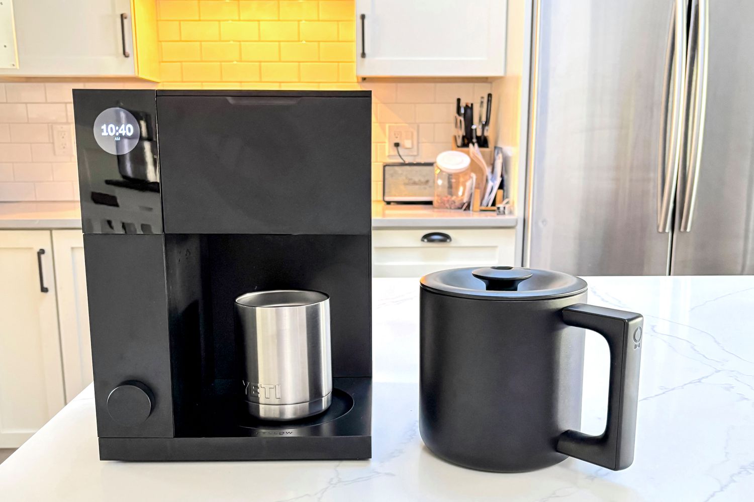 The Fellow Aiden brewing coffee into a coffee mug.