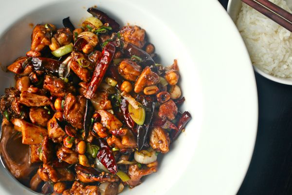 Overhead shot of a white dish of spicy Sichuan-style kung pao chicken