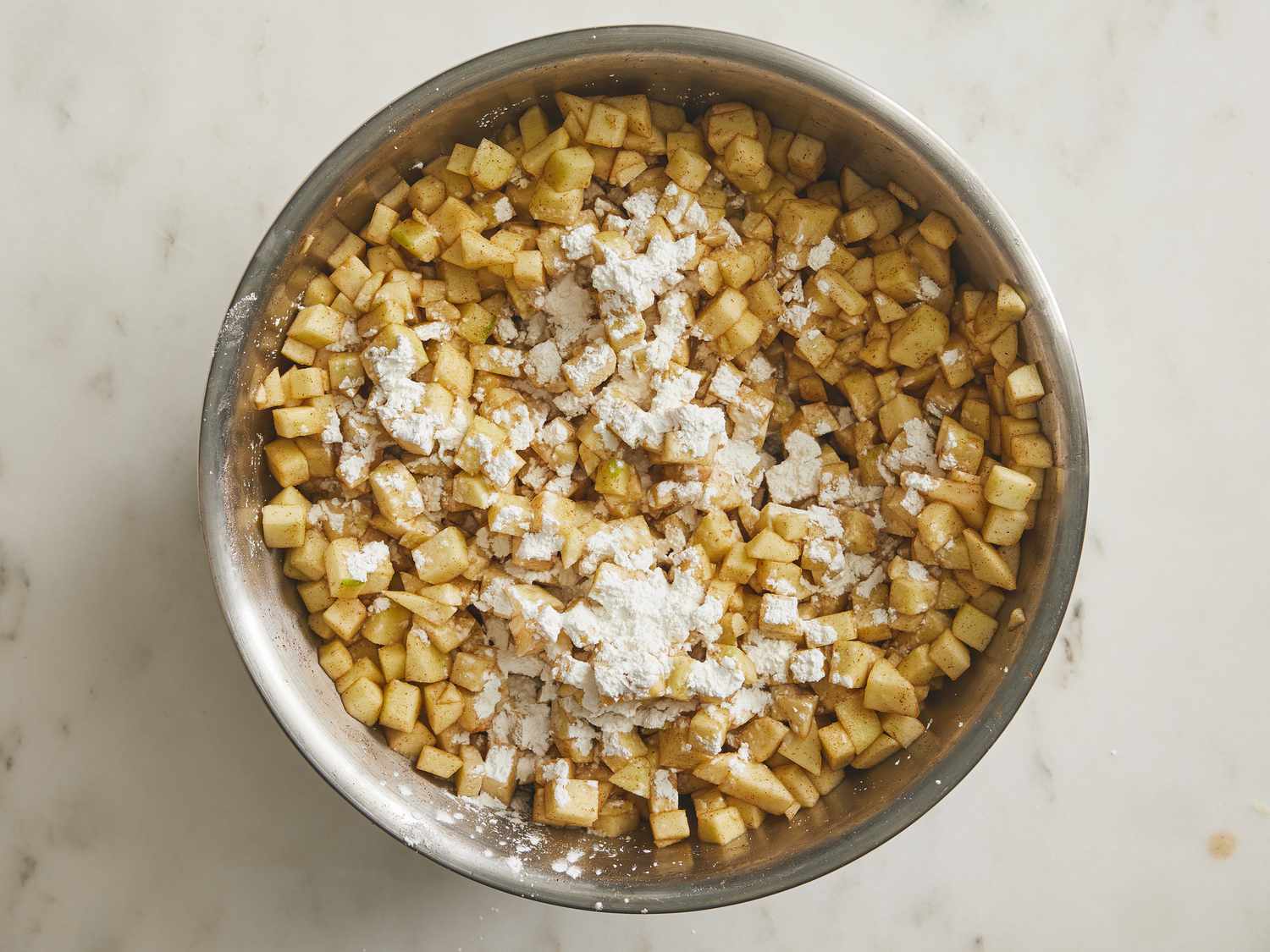 Cornstarch on top of apple mixture in a bowl
