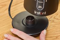 The Instant's milk frother pitcher being removed from its base.