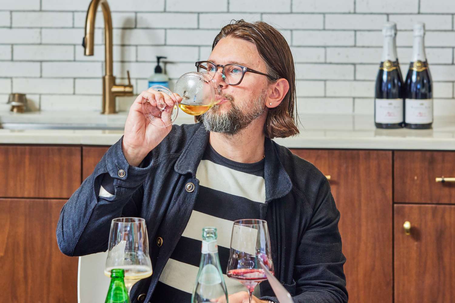 Person sipping white wine from Josephinenhütte Josephine No. 2 Universal Wine Glass