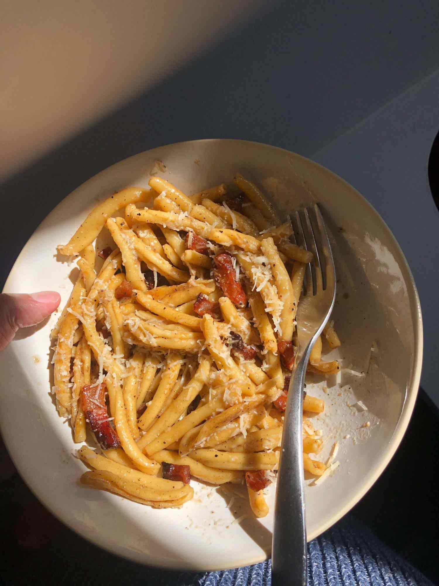 Joel's pasta alla gricia and weird thumb in a bowl