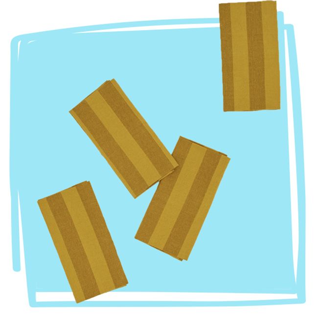 Four striped dinner napkins arranged on a blue background