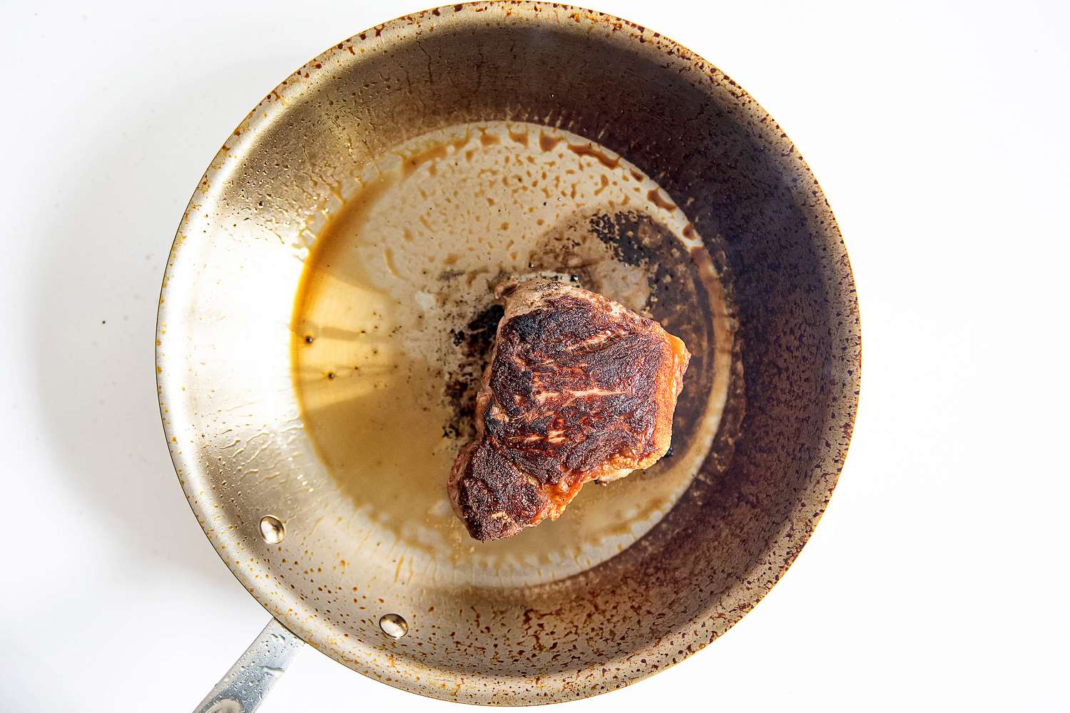 Food cooking in a pan from the All-Clad D3 3-Ply Stainless Steel Cookware Set 10 Piece