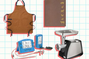 A collection of items including a meat grinder a cooking apron meat thermometers and a cookbook with animal silhouettes on the cover