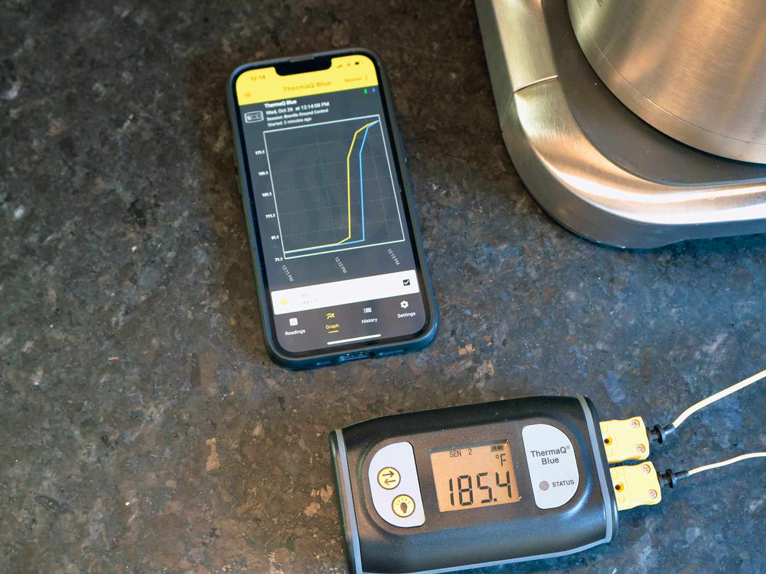 a thermoprobe shows a temperature of 185ÂºF next to an app on a phone graphing temperature rising