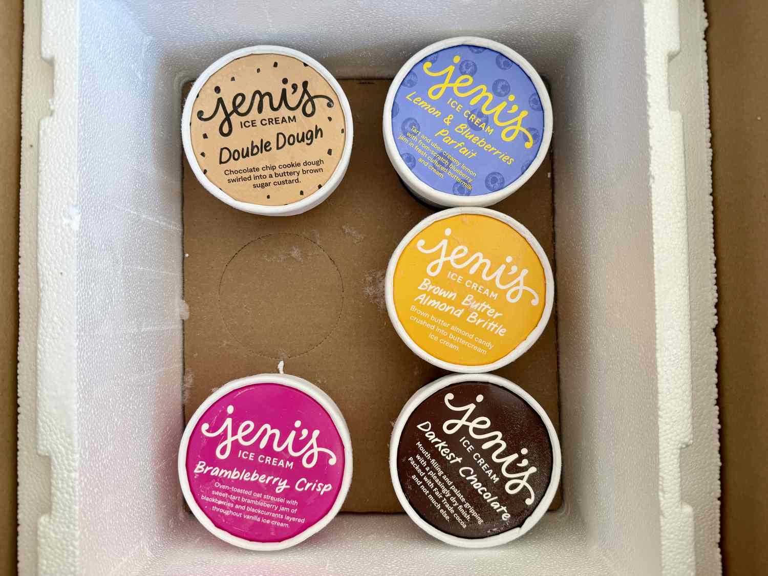 A styrofoam container of Jeni's ice cream pints