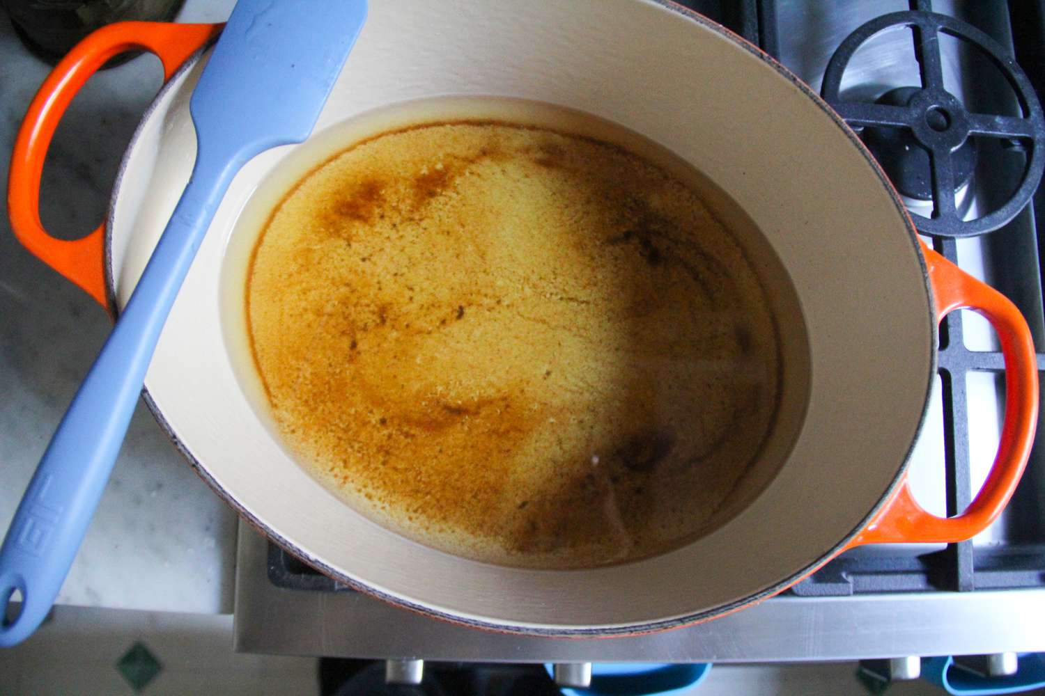 Oil in a pan with a spatula resting on top