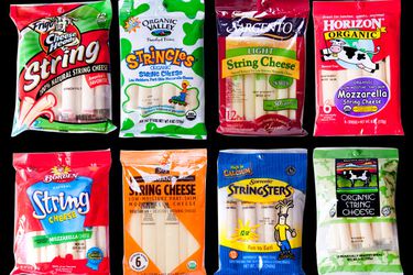 An assortment of eight different packages of string cheese. 