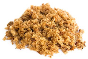 A pile of pork floss resting on a white surface.