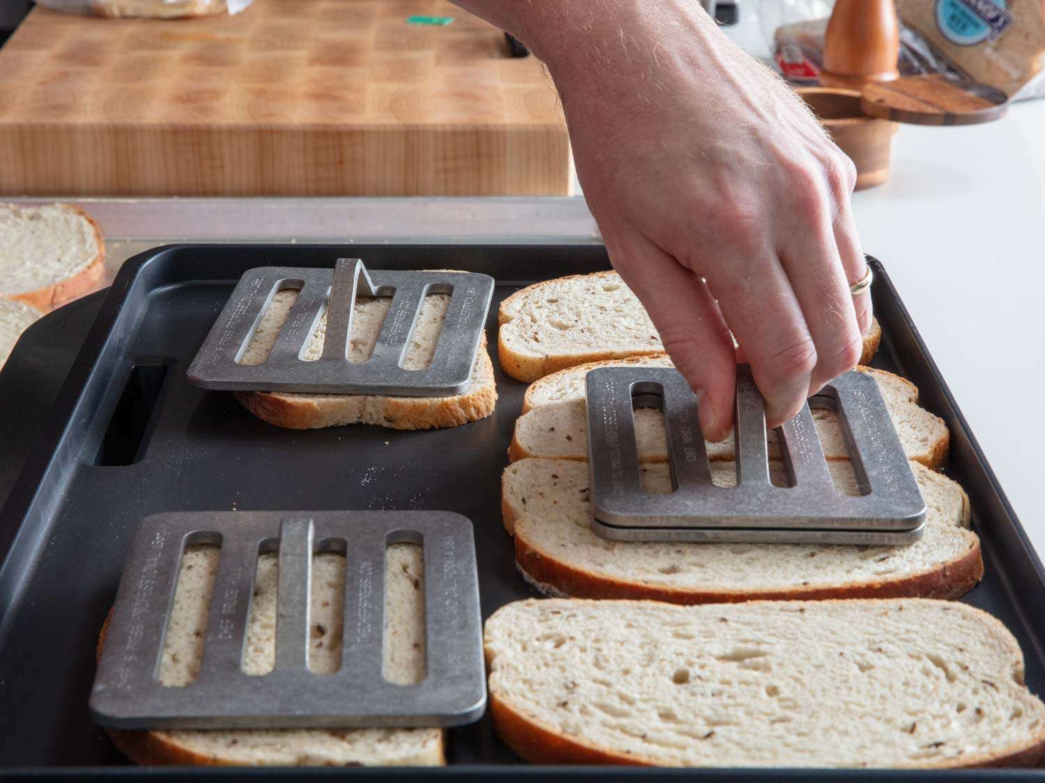 Placing Chefs Presses onto bread for turkey reuben sandwiches. 
