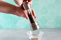 Person using Cole & Mason Derwent Pepper Grinder