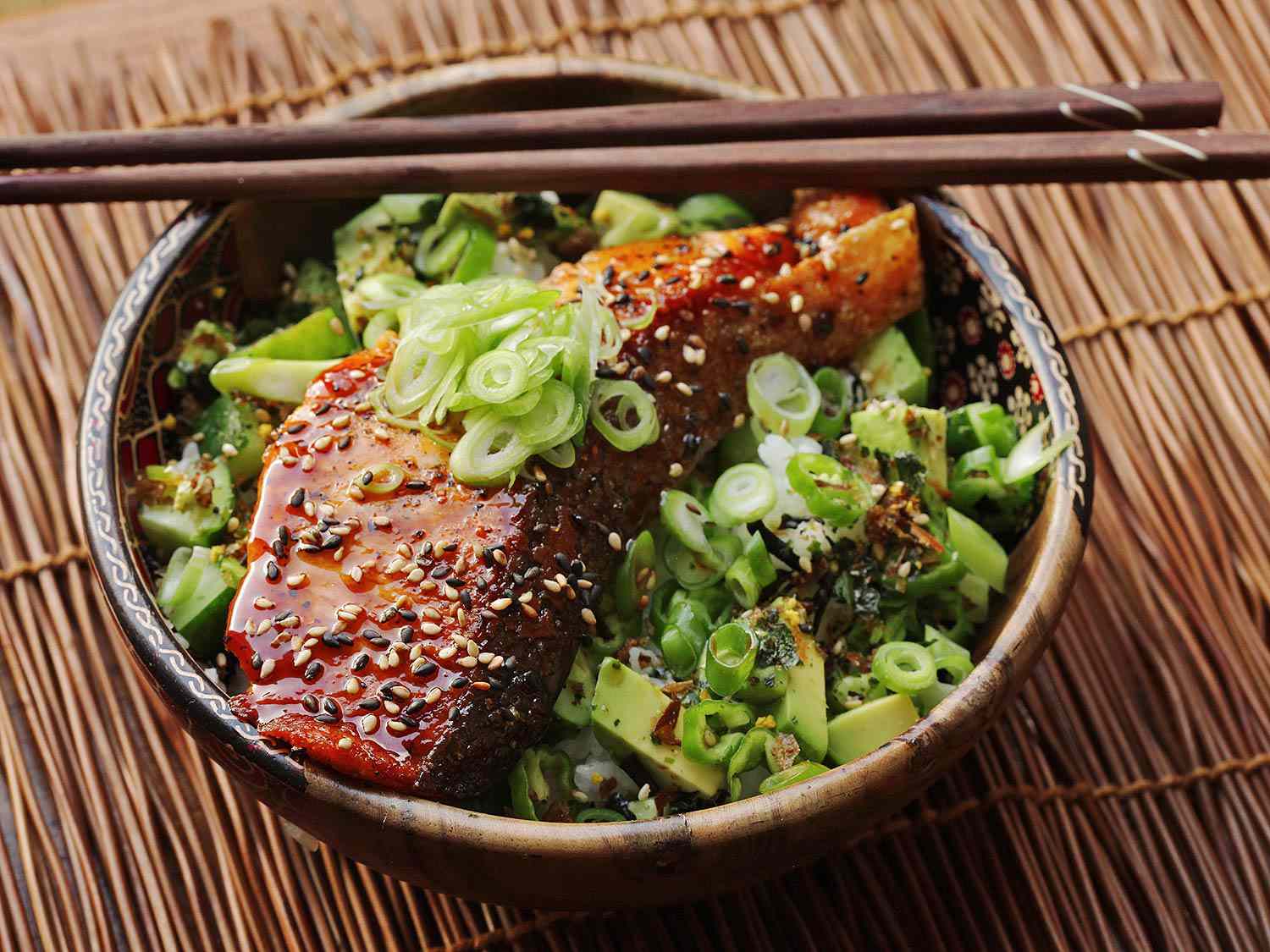 A teriyaki-glazed salmon, cucumber, and avocado rice bowl